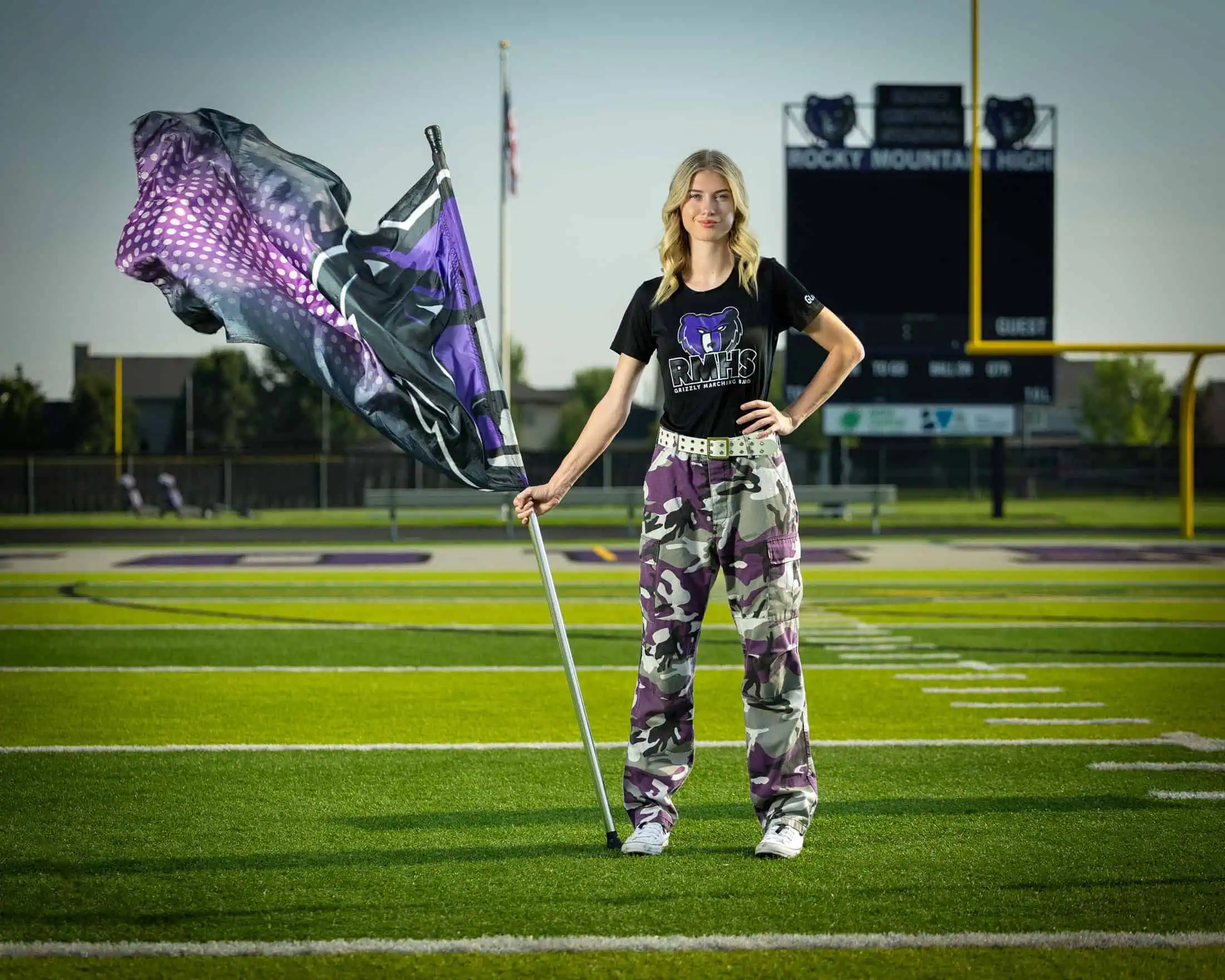 Rocky Mountain High School color guard performer with flag on football field in Boise Idaho